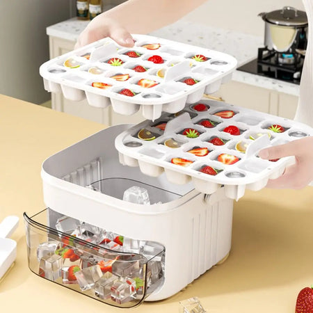 Ice cube tray with frozen cubes and strawberries in a kitchen setting