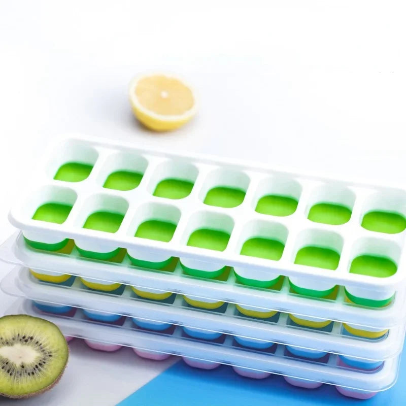 Stack of silicone ice cube trays with green, blue, and pink colors on a white background.